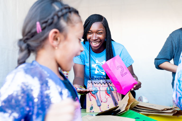 Festival volunteer leads activity about the skin and the sense of touch.
